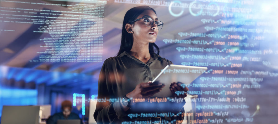 Attractive woman with glasses standing with data analytics in background