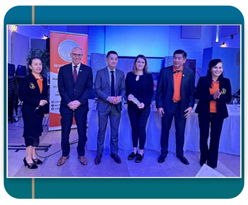 A group of people standing, looking at the camera at a conference.